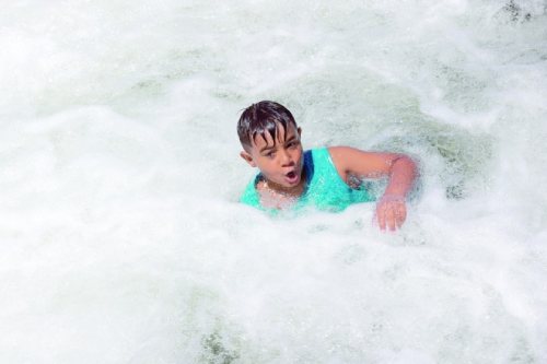 A boy plays in the Iber River in Mitrovica, Kosovo